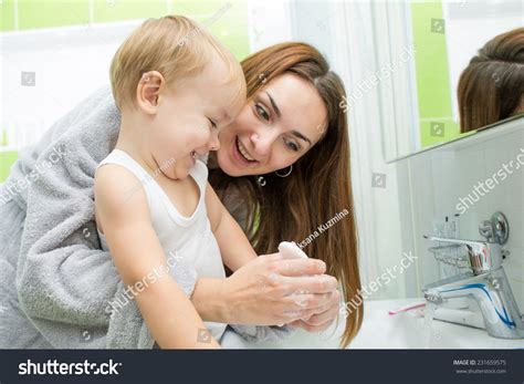 mom helps son bathroom